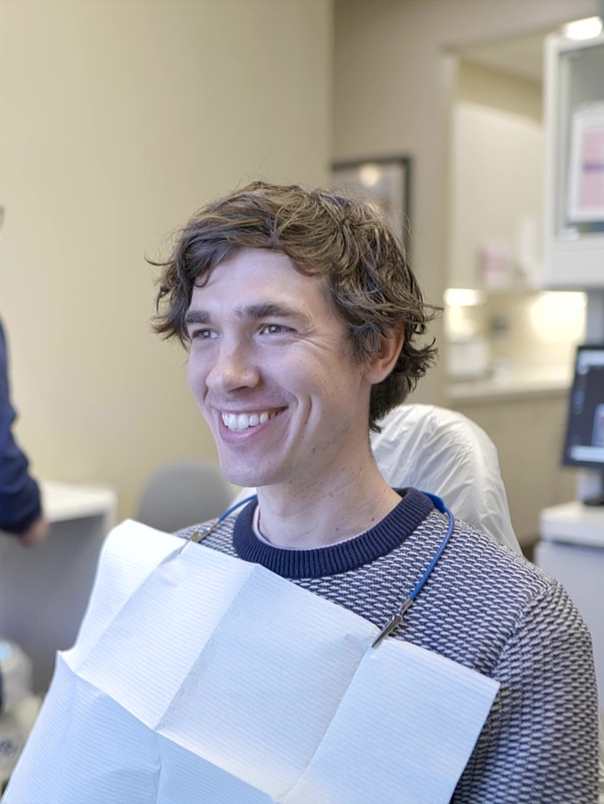 Young man grinning in dental chair