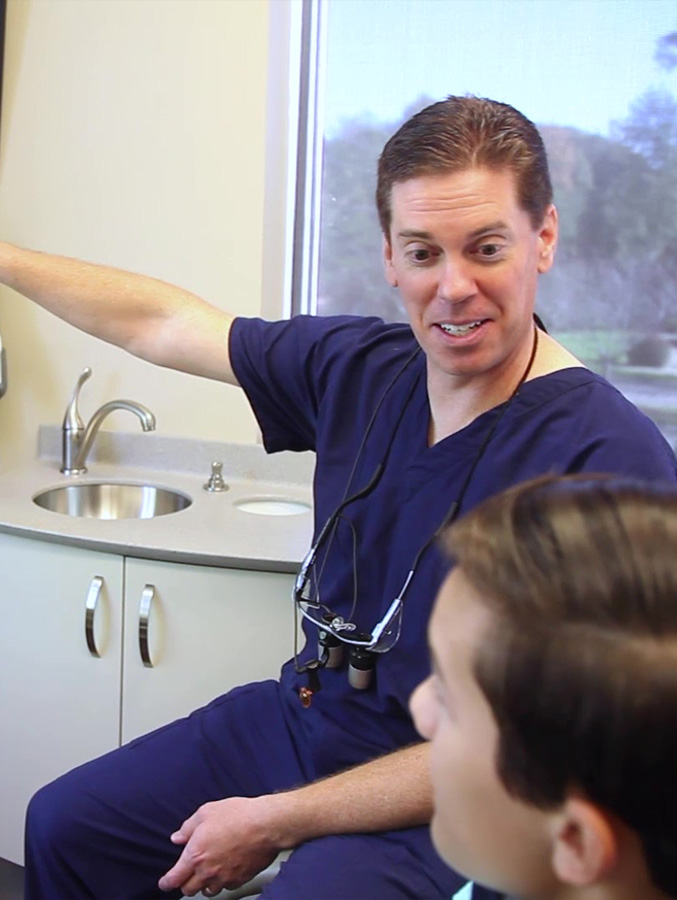 Dentist showing a patient something out of frame