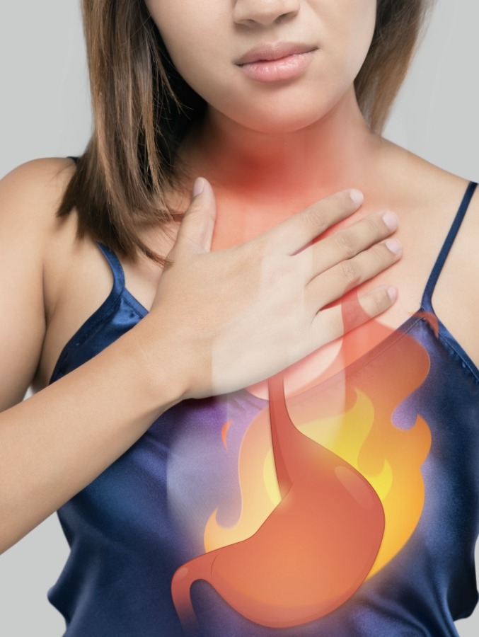 Woman touching her chest with animated stomach outlined in flames