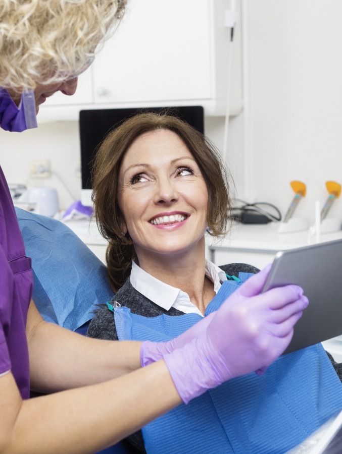 Woman smiling at her dentist during a dental checkup in Cary