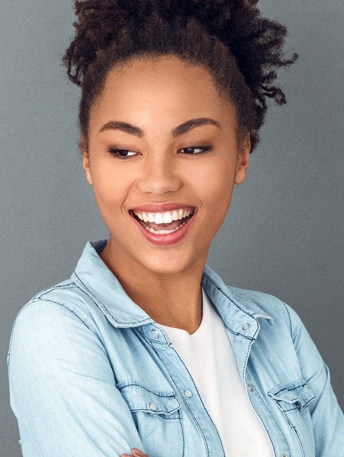 Smiling young woman in denim shirt