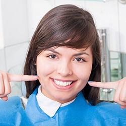 Female dental patient pointing to her smile