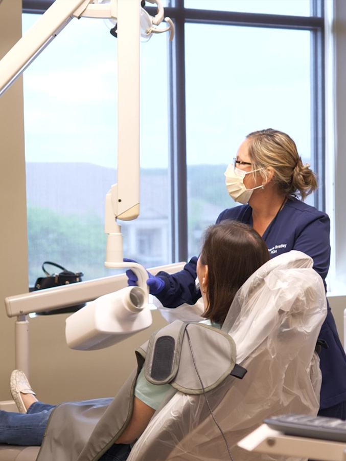 Dental team member taking dental x rays of a patient's mouth