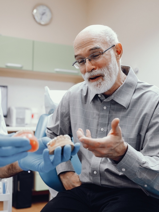 Older man talking to his dentist