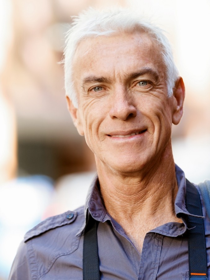 Senior man in gray collared shirt