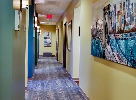 Dental office hallway branching off into dental treatment rooms