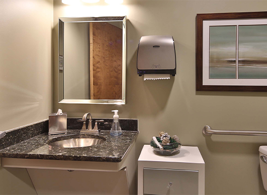 Mirror and sink in restroom of Cary dental office