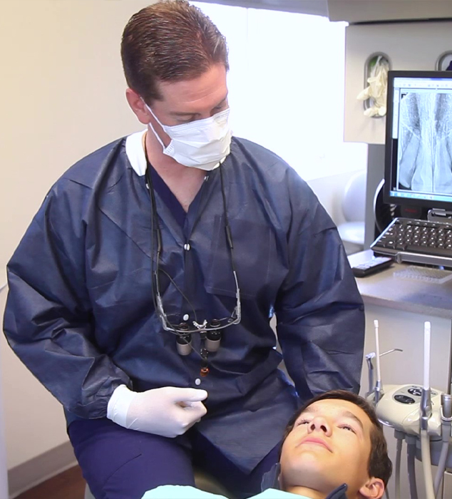 Cary dentist talking to young boy in dental chair