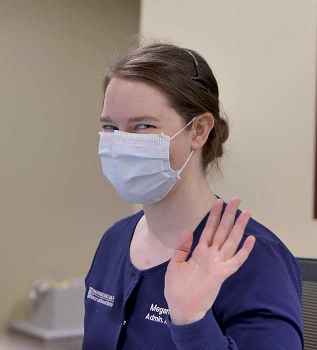 Dental team member with face mask waving
