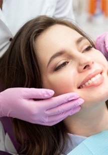 woman smiling in dental mirror 