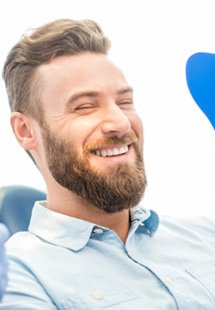 man smiling in dental mirror 