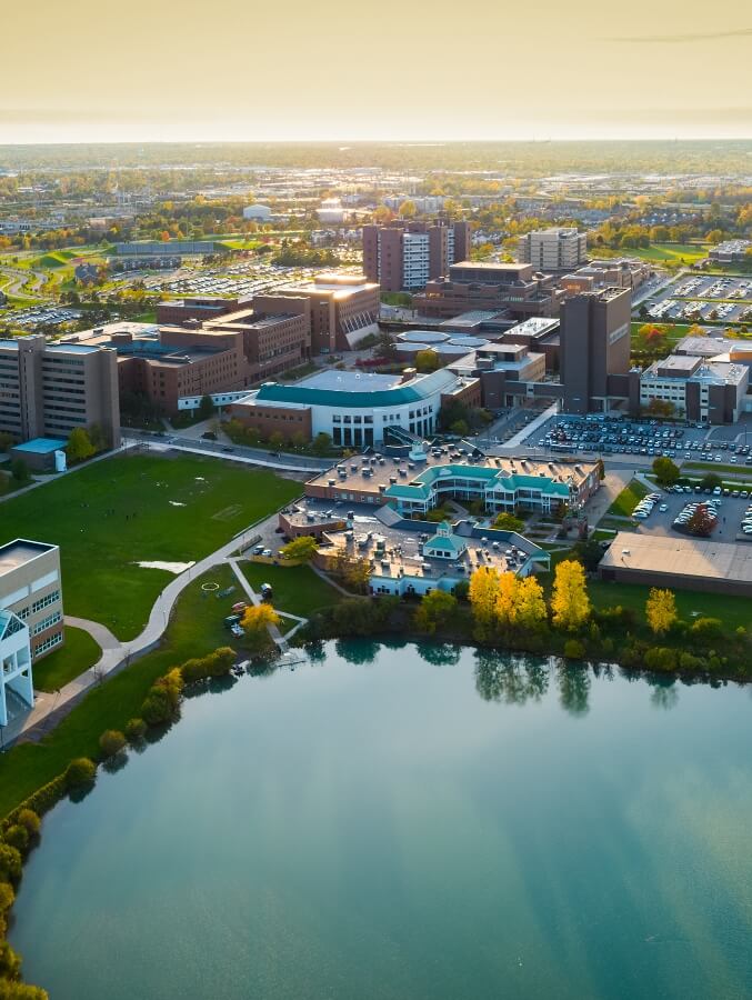 Aerial view of city next to pond