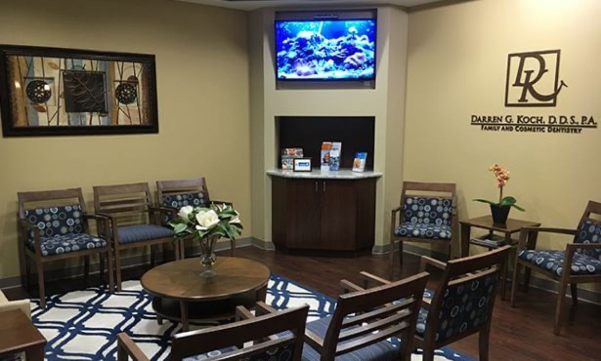 Television screen on wall of dental office reception area