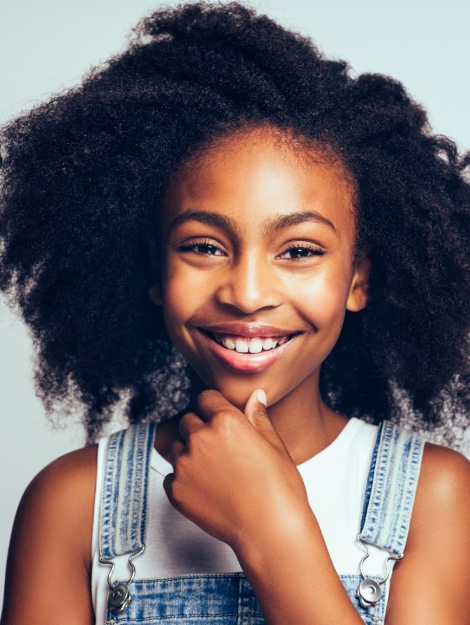 Young girl with overalls smiling