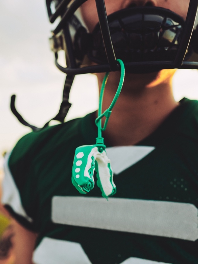 Mouthguard hanging from football helmet