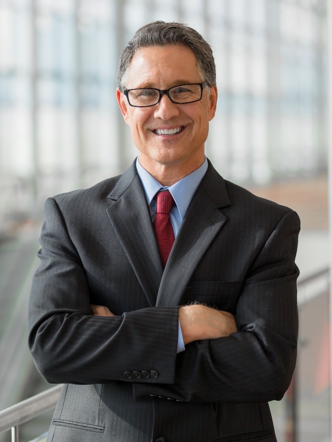 Businessman smiling and standing with arms crossed