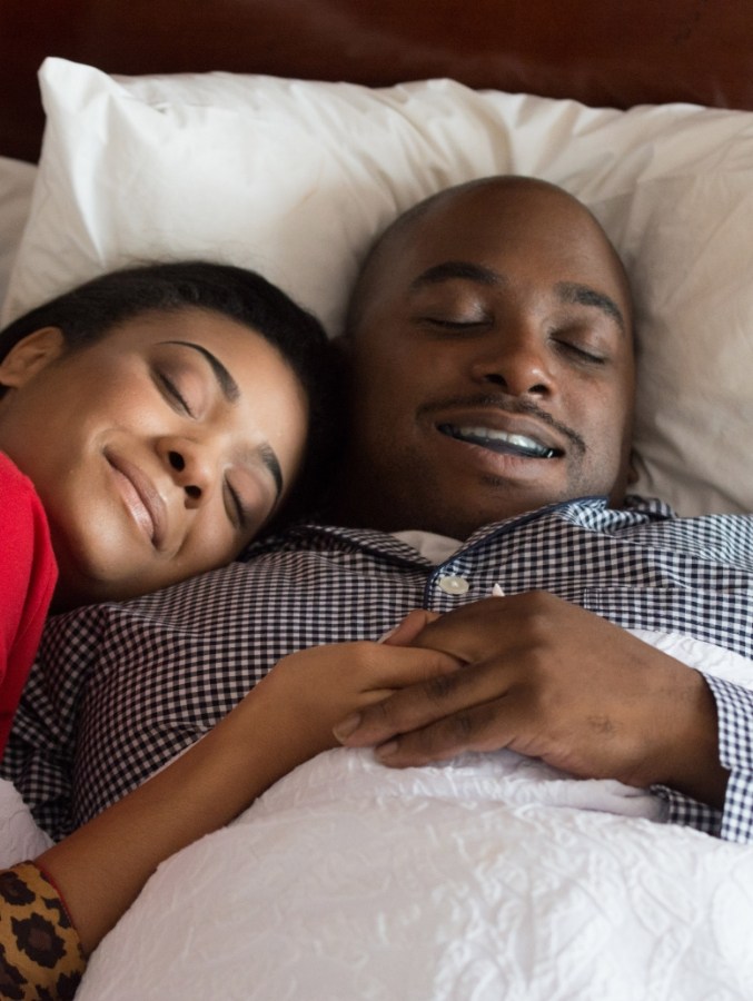 Man and woman snuggling while sleeping