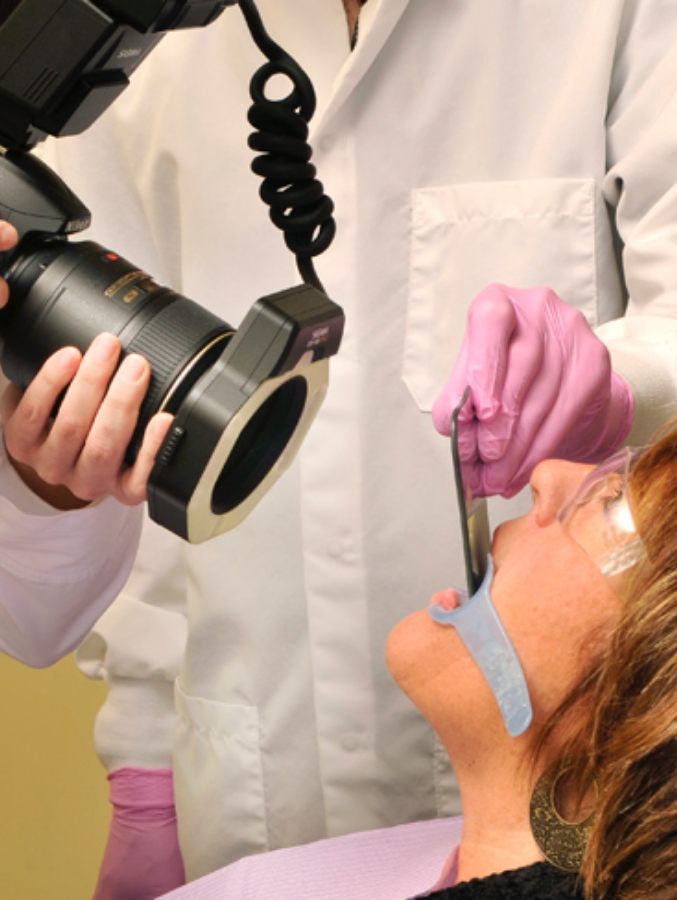 Dentist taking digital dental x rays of a patient's mouth