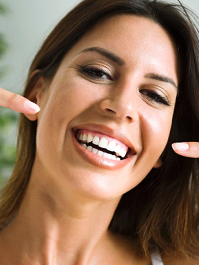 Smiling woman pointing to her teeth