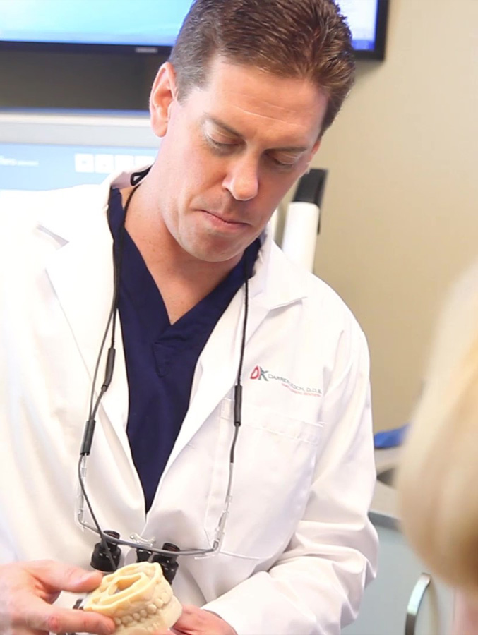 Doctor Koch holding a model of the teeth