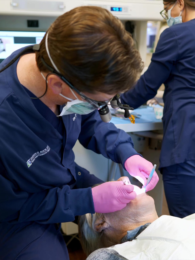 Doctor Koch treating a senior male dental patient