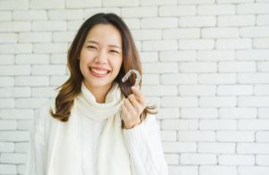 woman holding Invisalign