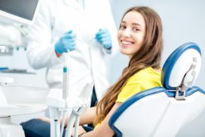 Woman smiling after seeing her emergency dentist