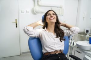 Woman smiling and relaxing in dental chair