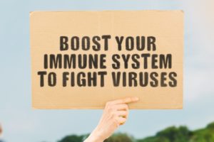 “boost your immune system to fight viruses” cardboard sign