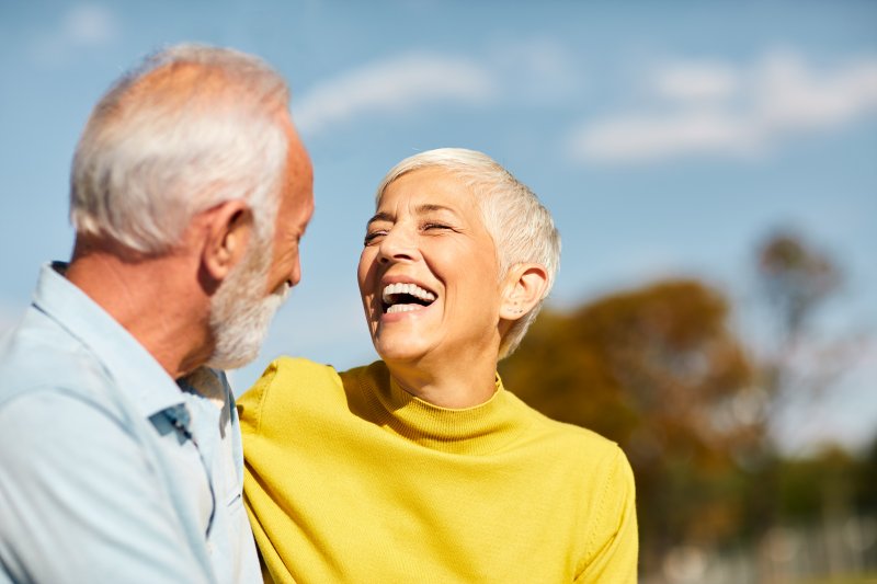 Senior couple smiling at each other outside