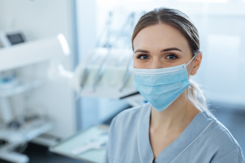 Closeup of dentist wearing a mask in treatment room