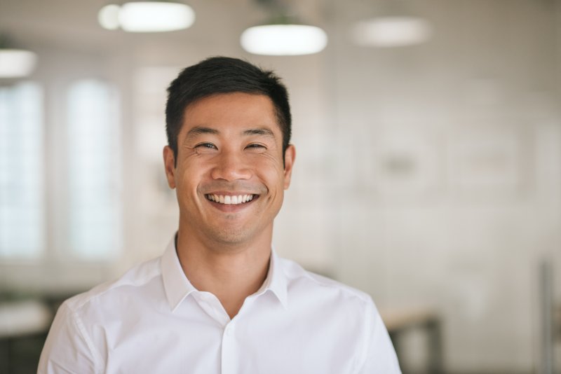 Man with dental implants smiling in room