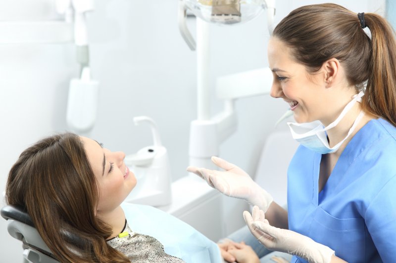 A female patient asking their dentist some questions