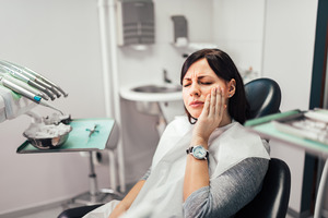 Woman with toothache at dentist’s office